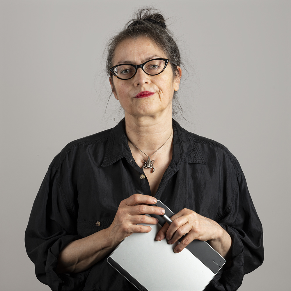 Image of photograph retoucher holding a digital pen and pad.